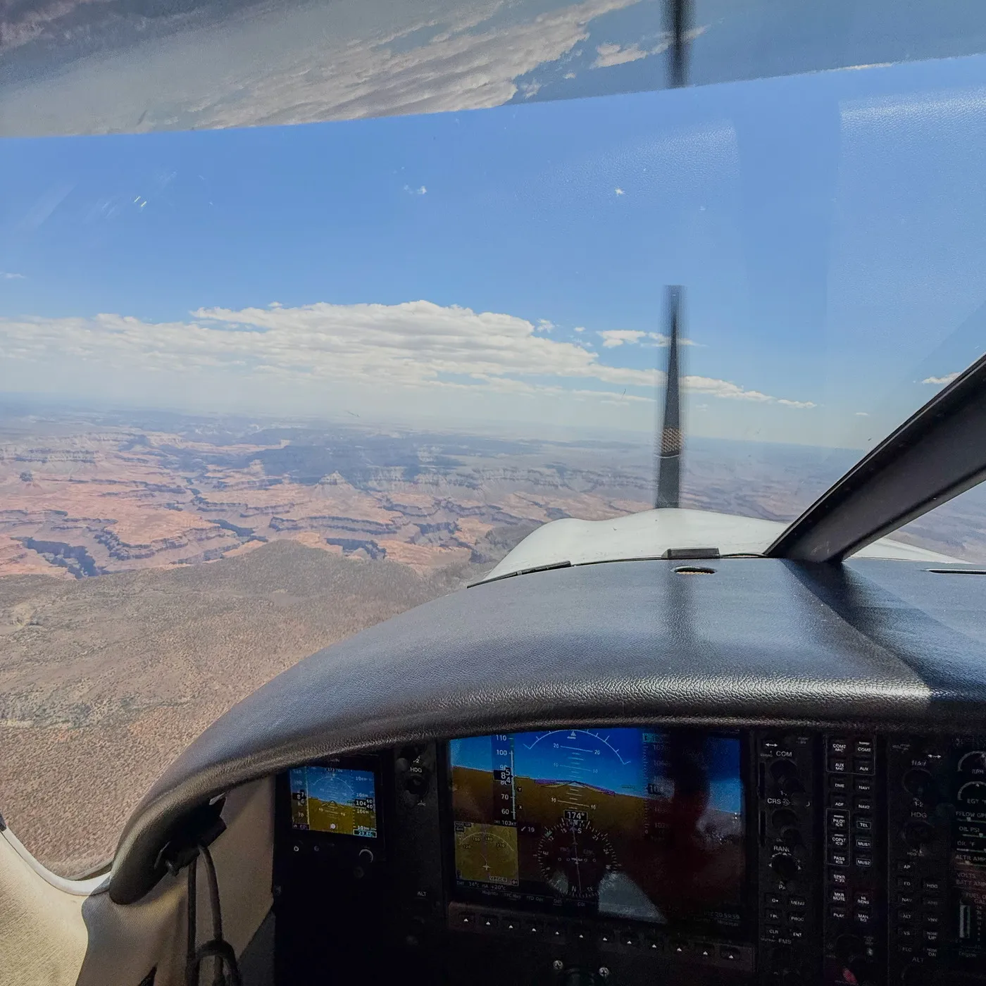 Canyon country out the windscreen above the glareshield and glass panel