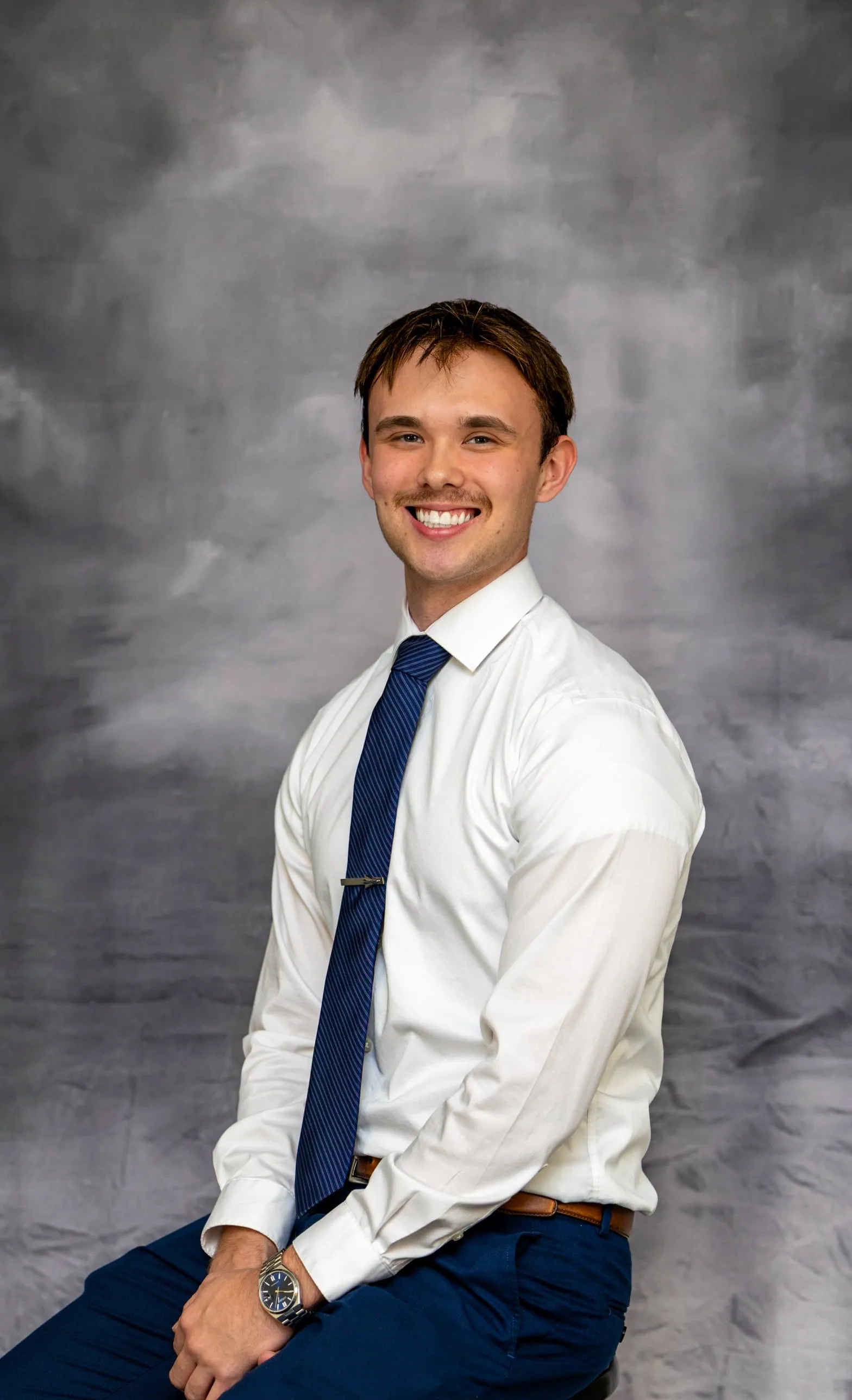 Portrait of Brandon J. Dorsey in a white shirt and navy tie