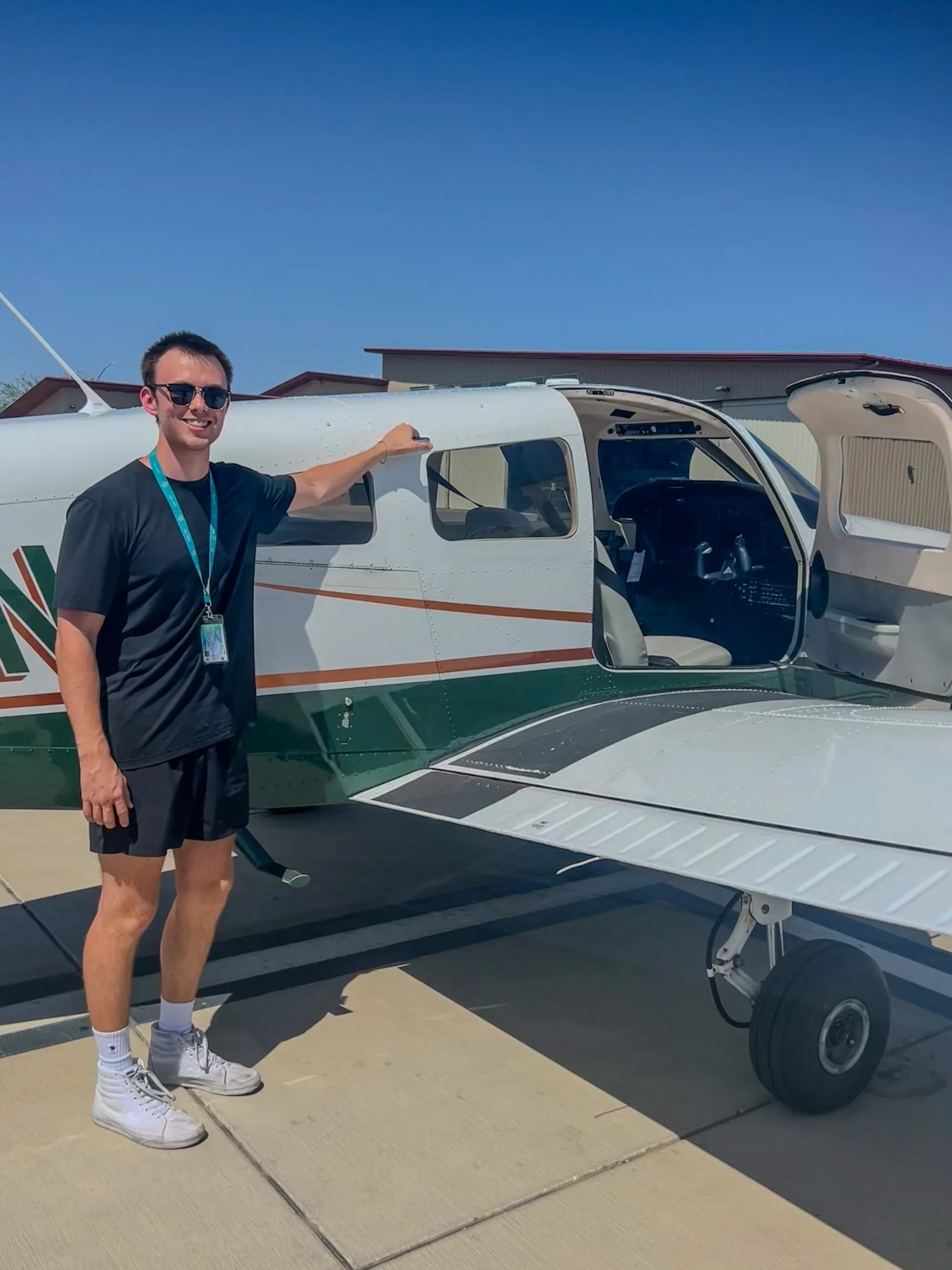 Brandon beside a Piper Archer with the door open on a hot Phoenix afternoon
