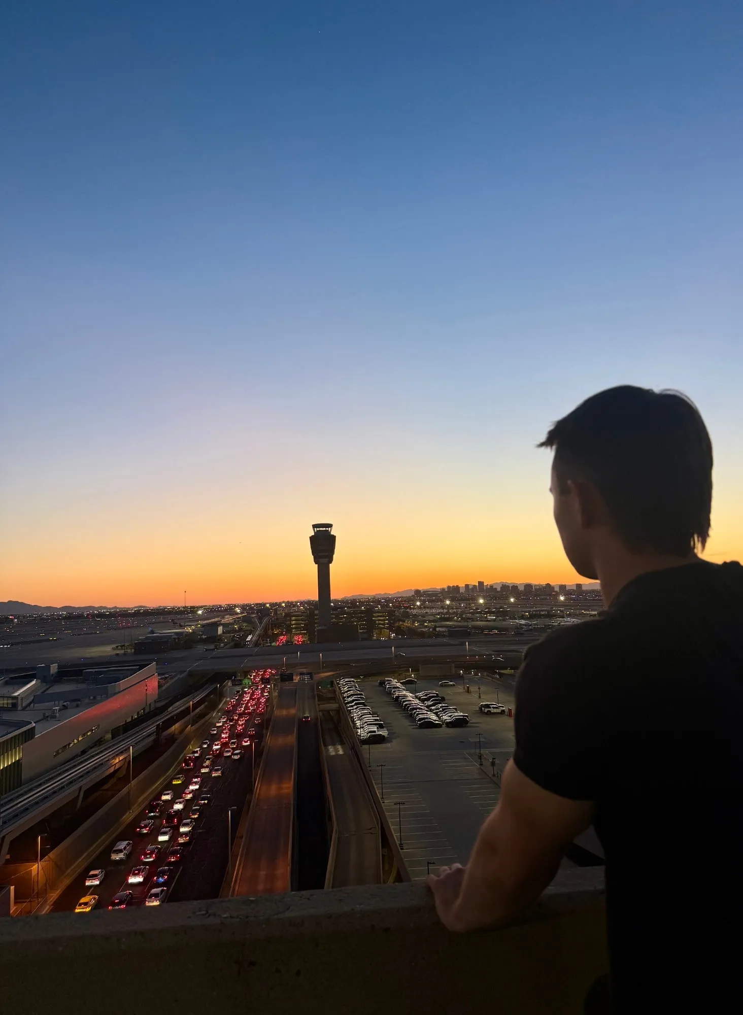 Brandon watching the sunset over the Phoenix Sky Harbor control tower